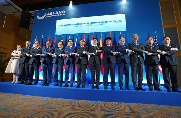 Secretary Rubio joins hands with ASEAN leaders for a photo.
