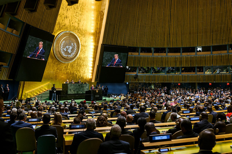 President Trump speaks from a lectern in the General Assembly Hall of the United Nations.