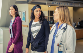 Photograph of three women walking outside a VA Women's Clinic
