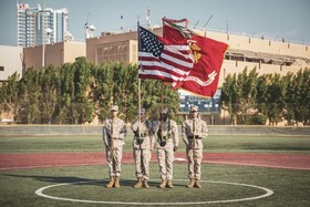 marines holding american flag and marine corps flag