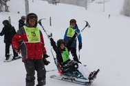 veteran and instructors skiing