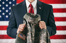 man in business suit holding army uniform