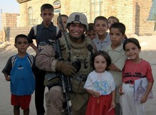 man in uniform flanked by children
