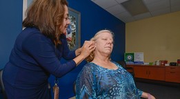 female veteran receiving battlefield acupuncture from female provider