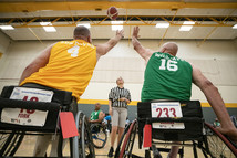 two men in wheelchair games competing in basketball
