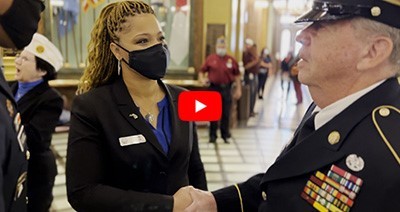 Woman Veteran shaking hands with a male Veteran.