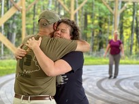 woman hugging man at travis mills foundation retreat