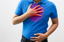 man grabbing chest from acid reflux