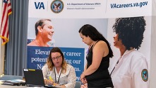 woman assisting other woman at va job fair