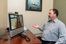 man talking with woman in virtual conference