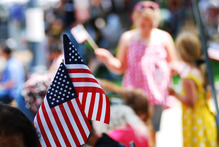 American flags waving at Veterans Day parade
