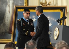 man in Army uniform wearing medal of honor shaking hands with President of the United States