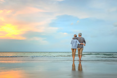 older couple on beach walking