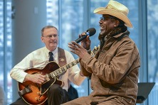 two veterans performing music on stage