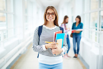 young woman in college building holding text books
