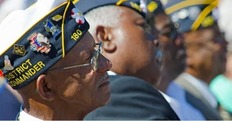 black military Veterans looking on during a ceremony