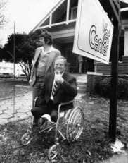 black and white photo of man in a wheelchair giving the thumbs up outside of a Vet Center