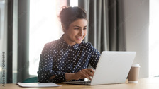 Woman looking at laptop.