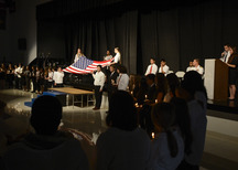 Students in school performing a Veterans day ceremony.