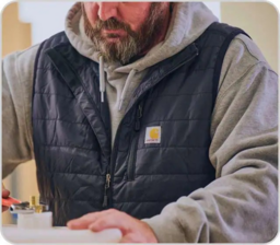 Man wearing a Carhartt vest.