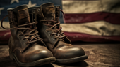 Military style boots with an American flag in the background.