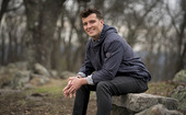 Man sitting on stone.