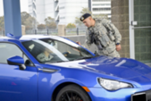 Person in car driving up to military installation gate access point.