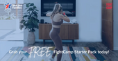 Woman doing a boxing workout in front of tv.