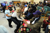 Woman shaking hands with Veteran.