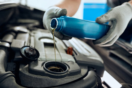 Pouring oil into engine during oil change.