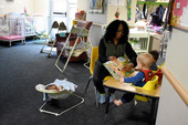 Woman reading to small children.