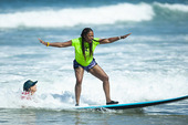 Female Veteran surfing.