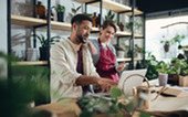 Man and woman working at small business plant and flower shop.