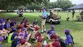 Instructor leading a group of young people.