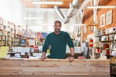 Man standing at the counter of his small business.