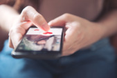 Woman using online dating app on a smartphone.