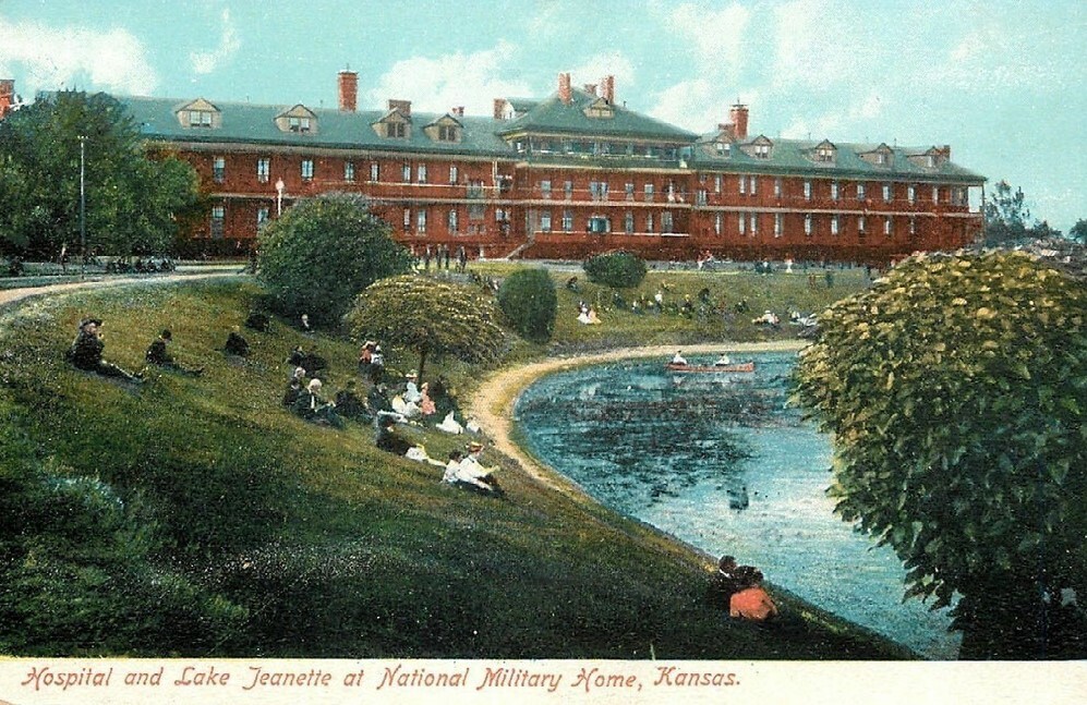 Postcard depicting visitors and residents enjoying a leisurely moment on the banks of Lake Jeanette at the Leavenworth Branch of the National Home.