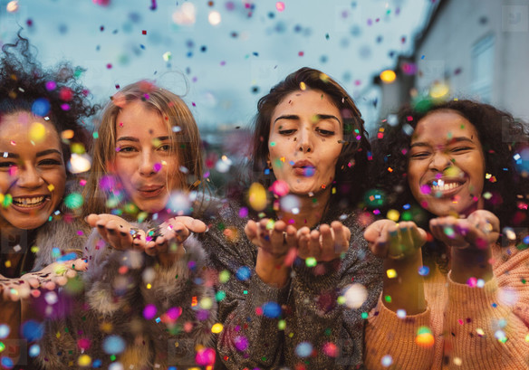 Women blowing confetti