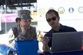VA employee helping a Servicemember with a laptop.