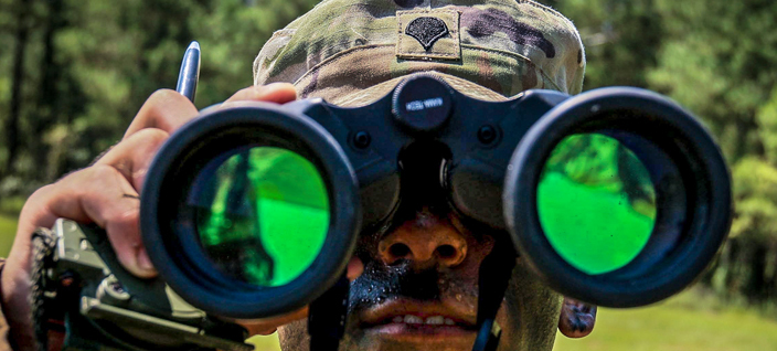 soldier looking through binoculars