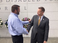 Dr. Paul R. Lawrence shaking hands with a Veteran
