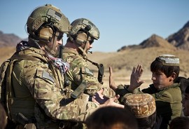 Service members receive high fives from children in Farah province, Afghanistan