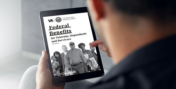 Veteran reading the 2021 Federal Benefits Handbook for Veterans, Dependents and Survivors