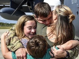 Air Force Technical Sergeant hugs his family
