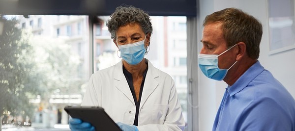 Doctor giving man a hearing exam