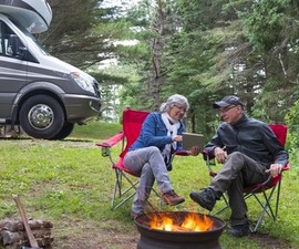 Man and woman enjoying a campfire