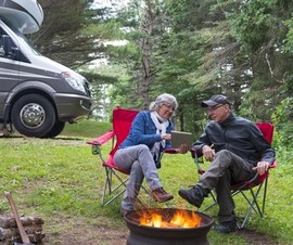 Man and woman enjoying a campfire