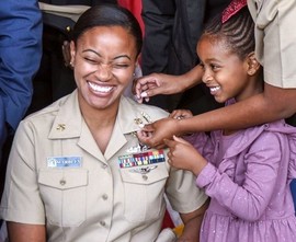 Navy chief petty officer’s daughters help pin anchors to her uniform