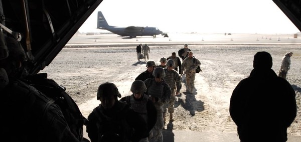 Service members embark a C-130H Hercules aircraft