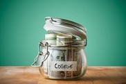 lidded jar with money inside and a label that reads college